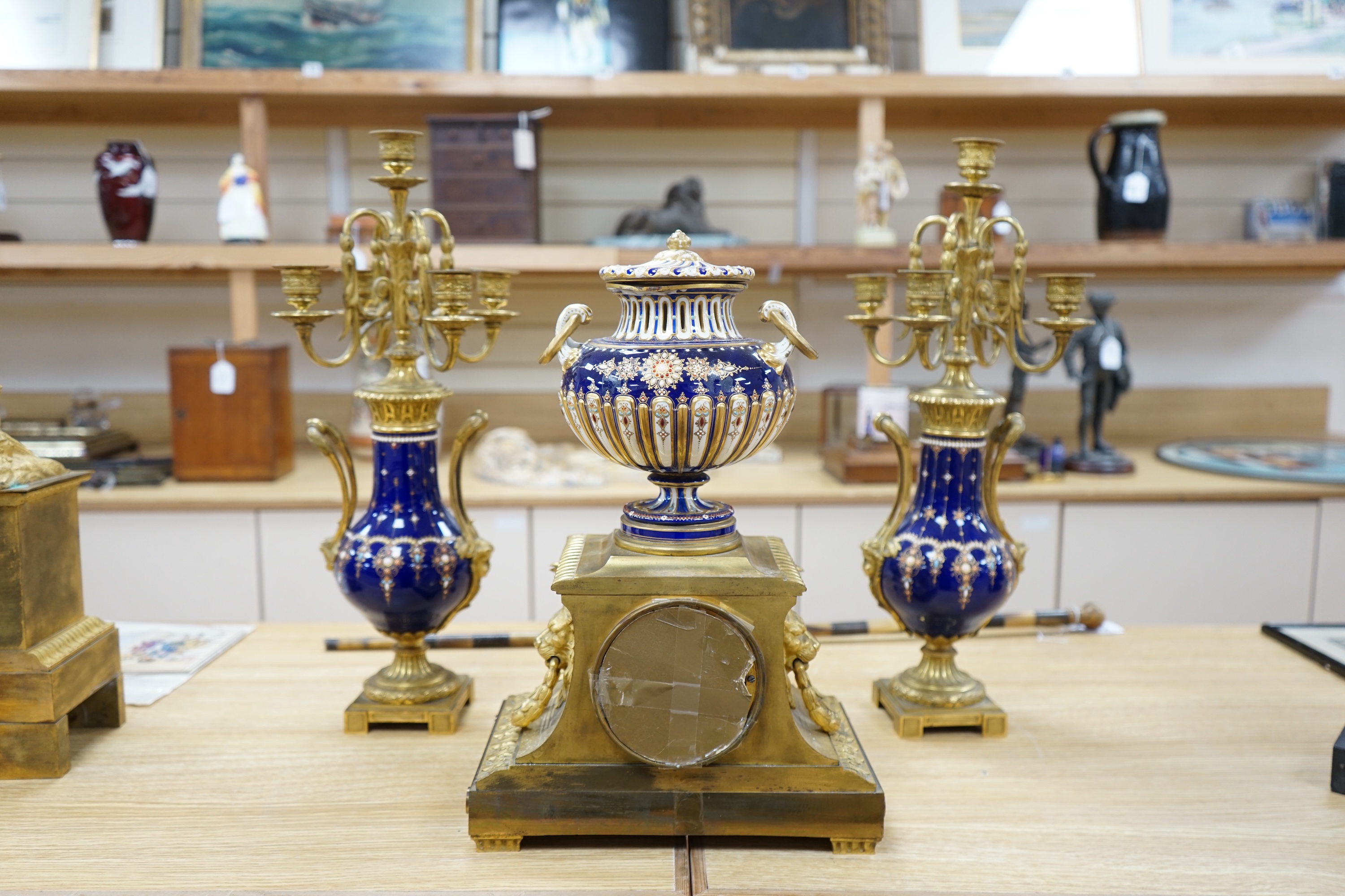 A 19th century Sevres style jewelled porcelain and ormolu matched clock garniture, striking on a bell, with pendulum, 51cm high. Condition - fair to good, minor restoration, untested